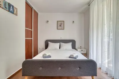 a bedroom with a bed with two towels on it at Sea Elegance Rafailovici in Rafailovici