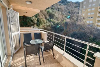 a balcony with two chairs and a table on a balcony at Seabreeze Rafailovici in Rafailovici