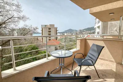 a balcony with two chairs and a table and a view at Seabreeze Rafailovici in Rafailovici