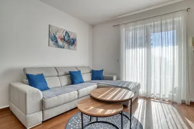 a living room with a couch and a table at Seabreeze Rafailovici in Rafailovici