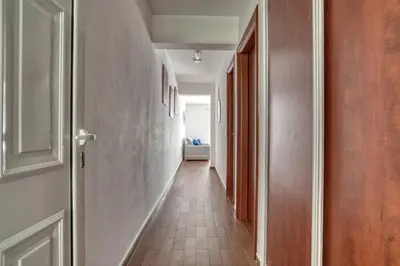 an empty hallway with a door and a hallwayngth at Seabreeze Rafailovici in Rafailovici