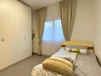 a bedroom with a bed and a window at Tivat Garden Apartments - Near Airport & Beach, Quiet Stay in Tivat
