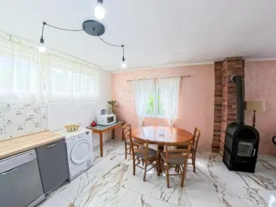 a kitchen with a wooden table and a stove at Tivat Garden Apartments - Near Airport & Beach, Quiet Stay in Tivat