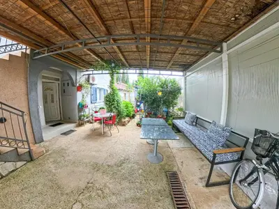 a patio with a bench and a table on a building at Tivat Garden Apartments - Near Airport & Beach, Quiet Stay in Tivat
