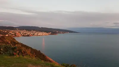 a view of a large body of water with a city at Emerald Dreamscape with Private Beach & Pool in Dobra Voda
