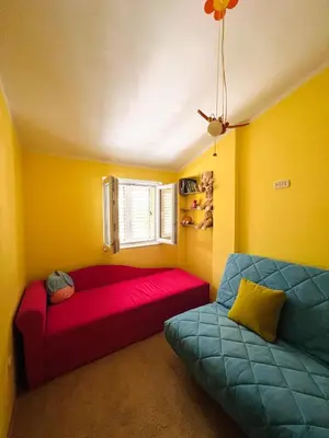 a living room with a red couch and a window at La Lumiere Perazica Do in Perazića Do