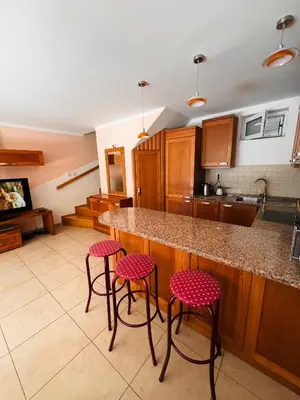 a kitchen with a counter and four stools at La Lumiere Perazica Do in Perazića Do