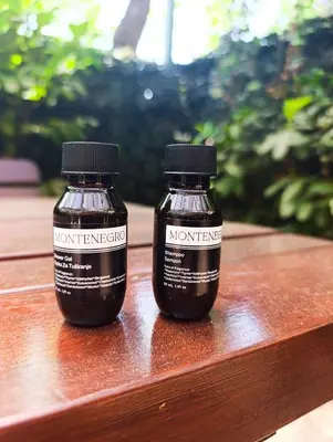two bottles of peanut butter sitting on a wooden table at La Lumiere Perazica Do in Perazića Do