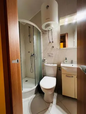a bathroom with a toilet and a shower and a sink at La Lumiere Perazica Do in Perazića Do