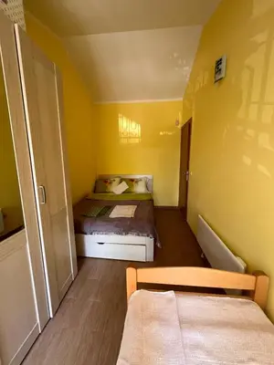 a small bedroom with yellow walls and a bed at La Lumiere Perazica Do in Perazića Do
