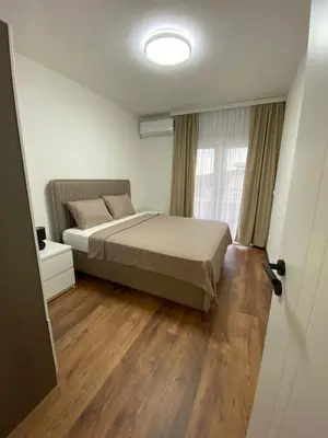 a bedroom with a bed and a window at Apartament Adian in Ulcinj