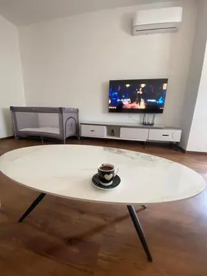 a coffee table in a living room with a cup of coffee at Apartament Adian in Ulcinj