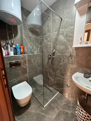a bathroom with a shower with a toilet and a sink at Apartment ViSi 101 in Budva