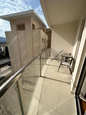 a balcony with a table and a chair on a building at Apartment ViSi 101 in Budva