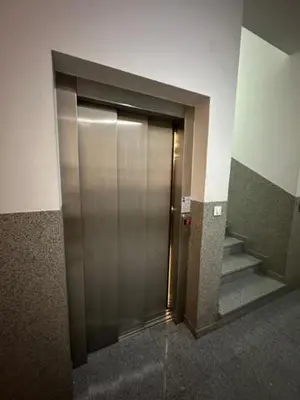 a metal elevator door in a building with stairs at Apartment ViSI 102 in Budva