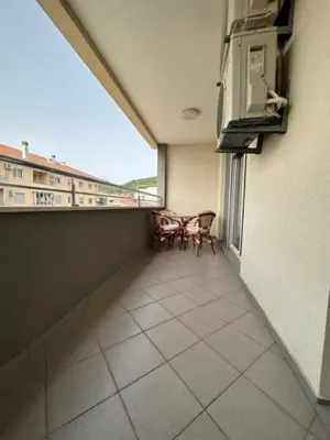 an empty balcony with two chairs and a window at Apartment ViSI 102 in Budva