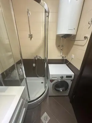 a small bathroom with a washing machine and a sink at Apartment ViSI 102 in Budva