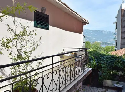 a balcony with a black railing and a building at Apartments Ivanovic in Budva