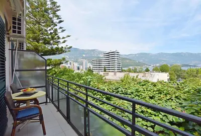 a balcony with a table and a view of a city at Apartments Ivanovic in Budva