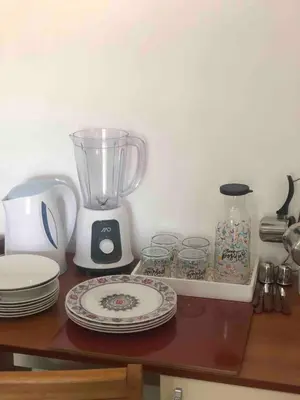a table with a blender and plates on it at NIDA Apartment in Ulcinj