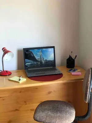 a laptop computer sitting on top of a wooden desk at NIDA Apartment in Ulcinj