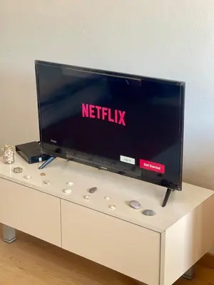 a flat screen tv sitting on top of a white dresser at NIDA Apartment in Ulcinj