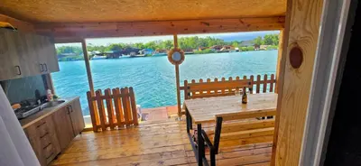 a kitchen and a table with a view of the water at River house Una in Kravlja