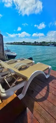 a pair of lounge chairs sitting on a dock next to the water at River house Una in Kravlja