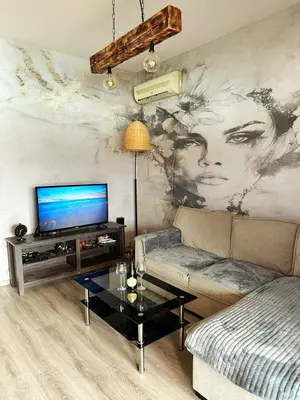 a living room with a couch and a tv at River house Una in Kravlja