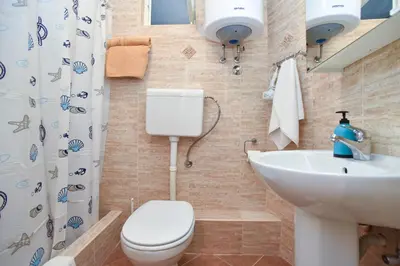 a bathroom with a toilet and a sink at Sailor House in Budva