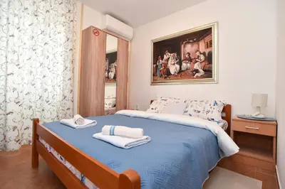 a bedroom with a bed with towels on it at Sailor House in Budva