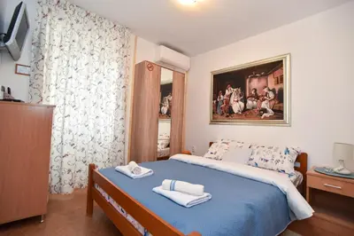 a bedroom with a bed with two towels on it at Sailor House in Budva