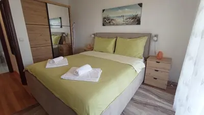a bedroom with a bed with two towels on it at Apartment Ulcinj in Ulcinj
