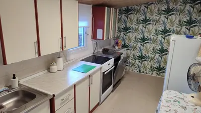 a small kitchen with a sink and a refrigerator at Holiday home Sutomore in Sutomore