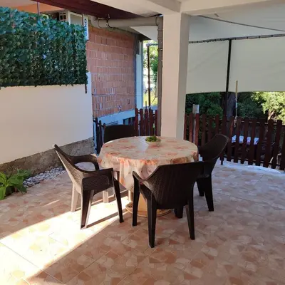 a table and chairs sitting on a patio at Holiday home Sutomore in Sutomore