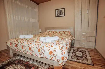 a bedroom with a bed with two towels on it at Apartman Damjanovic in Cetinje