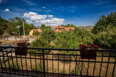 a wrought iron fence with flower pots on it at Apartman Damjanovic in Cetinje