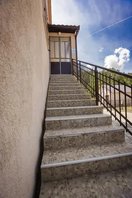 a set of stairs leading to a building with a door at Apartman Damjanovic in Cetinje