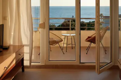a room with a balcony with a view of the ocean at Apartment SeaView in Utjeha