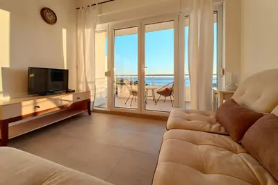 a living room with a couch and a view of the ocean at Apartment SeaView in Utjeha