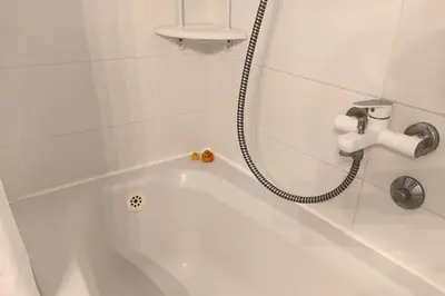 a bathroom with a bath tub with a shower at Apartment SeaView in Utjeha