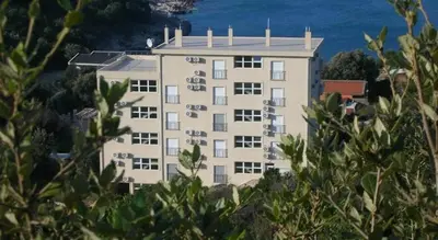 a large building with the ocean in the background at Apartment SeaView in Utjeha