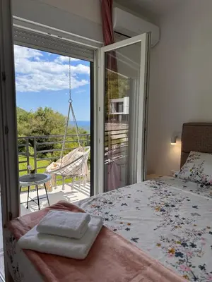 a bedroom with a bed and a sliding glass door at Villa Aurora in Gorovići
