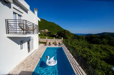 a swimming pool with an inflatable dolphin in a house at Villa Aurora in Gorovići