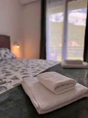 a pile of towels sitting on top of a bed at Villa Aurora in Gorovići
