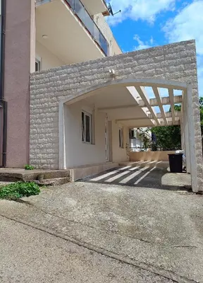 a garage with a stone wall and an open door at Jasmin 2 in Ulcinj