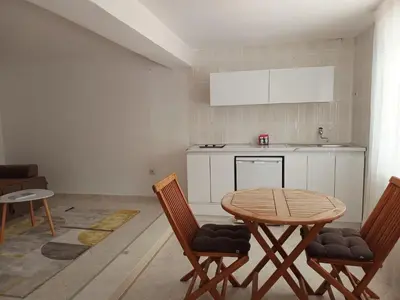 a kitchen with a table and two chairs and a table at Jasmin 2 in Ulcinj