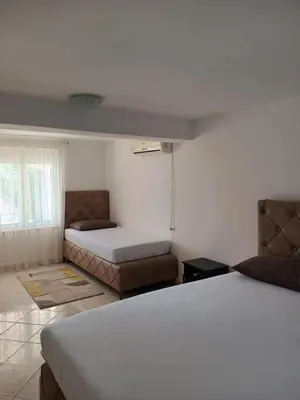 a bedroom with two beds and a couch at Jasmin 2 in Ulcinj