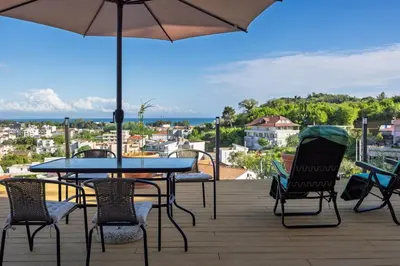 a patio with a table and chairs and an umbrella at Gjerana SEAVIEW in Ulcinj