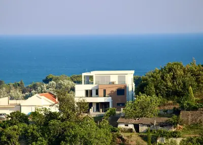 a house on a hill with the ocean in the background at Gjerana SEAVIEW in Ulcinj